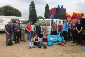 Seventeen of the Danson clean-up volunteers pose with the bags of collected rubbish at the conclusion of the event