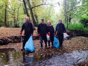 Friends of the Shuttle team members clearing litter from the river in Bexley Woods. (Photo: Jane Stout)