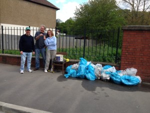 Posing with the haul of recyclables and other material, including a chair and a scooter.