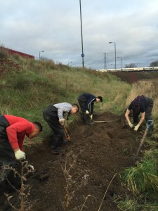 Crayford Academy pupils hard at work on the trench which, once planted up, is designed to intercept all oil residue washed off Thames Road and prevent it getting into the waterbody. 