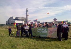 Save our Skylarks demonstrators line up for the photoshoot with Cory's incinerator in the background.